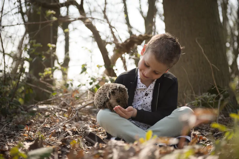 Communicant met egel op de schoot